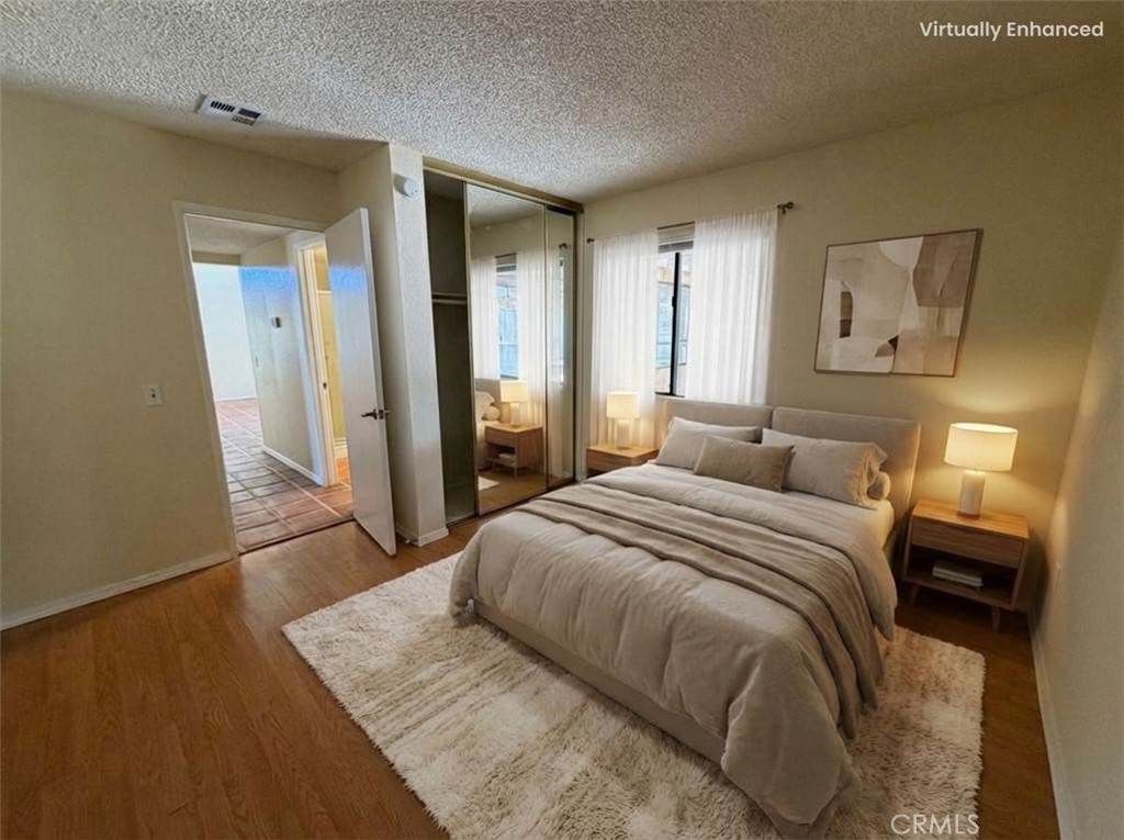 2560 East Ave R12 Palmdale, CA 93550 - Photo 8 of 26 a bedroom with a bed and a walk in closet