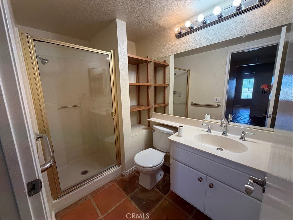 2560 East Ave R12 Palmdale, CA 93550 - Photo 9 of 26 a bathroom with a sink a toilet and shower