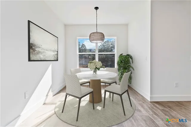 a dining room with furniture and window