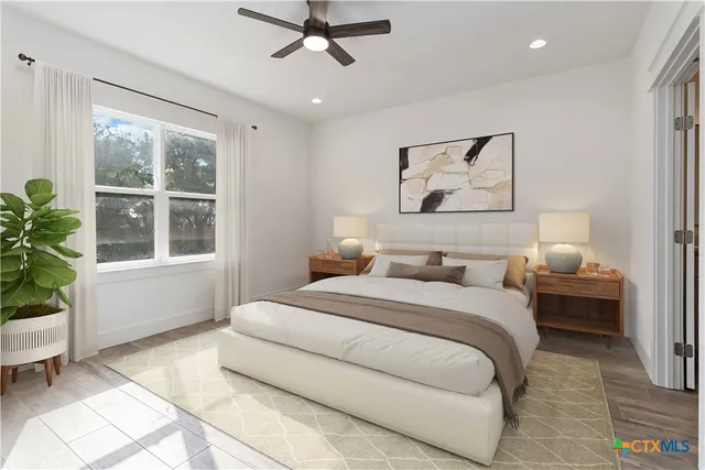 a bedroom with a large bed and a window