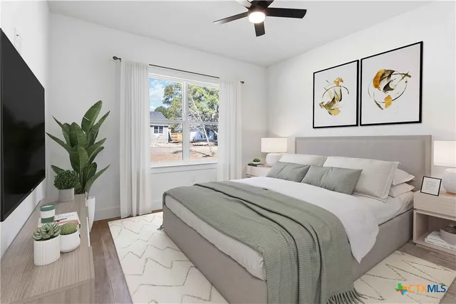 a bedroom with a large bed and a window