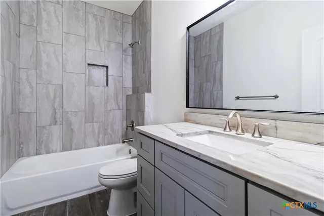 a kitchen with stainless steel appliances granite countertop a sink a stove and a wooden floors