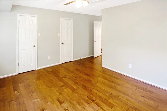 a en suite bathroom with a granite countertop sink and a mirror