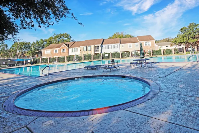 a view of backyard with wooden fence