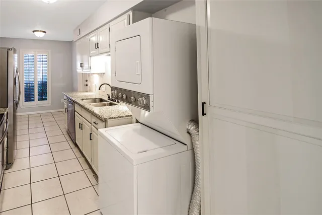 a kitchen with granite countertop a stove a microwave a sink and refrigerator