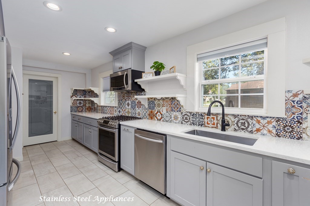 421 House Street Lufkin, TX 75904 - Photo 18 of 46 a kitchen with a sink stove and refrigerator