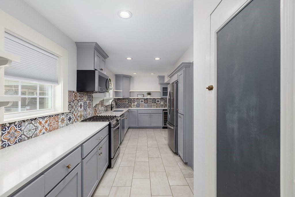 421 House Street Lufkin, TX 75904 - Photo 20 of 46 a kitchen with a sink a counter top space stainless steel appliances and a window