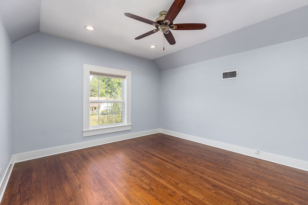421 House Street Lufkin, TX 75904 - Photo 33 of 46 an empty room with wooden floor ceiling fan and windows