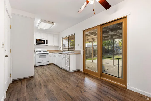 a kitchen with stainless steel appliances a stove top oven and a refrigerator
