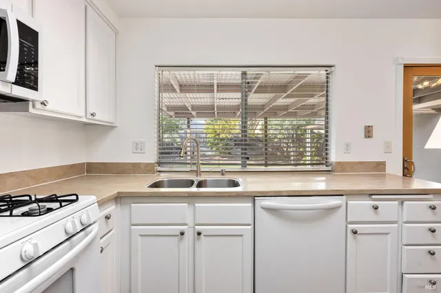 a kitchen with a sink and a stove