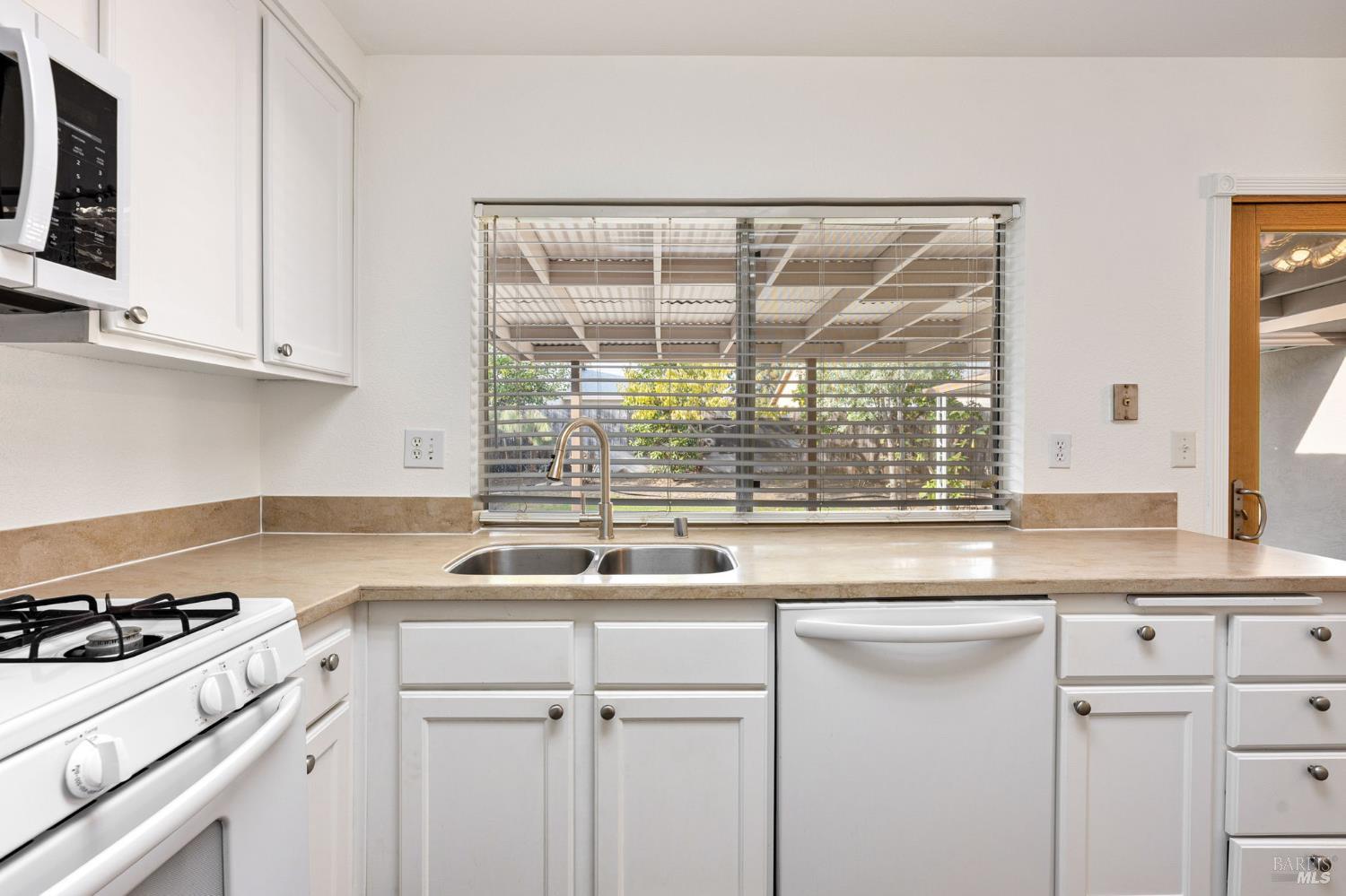 570 Berkeley Way Fairfield, CA 94533 - Photo 14 of 34 a kitchen with a sink and a stove