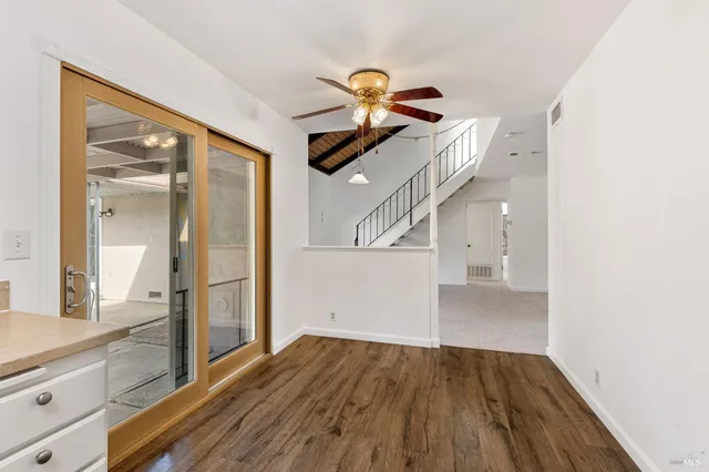 a view of a hallway view with wooden floor and staircase