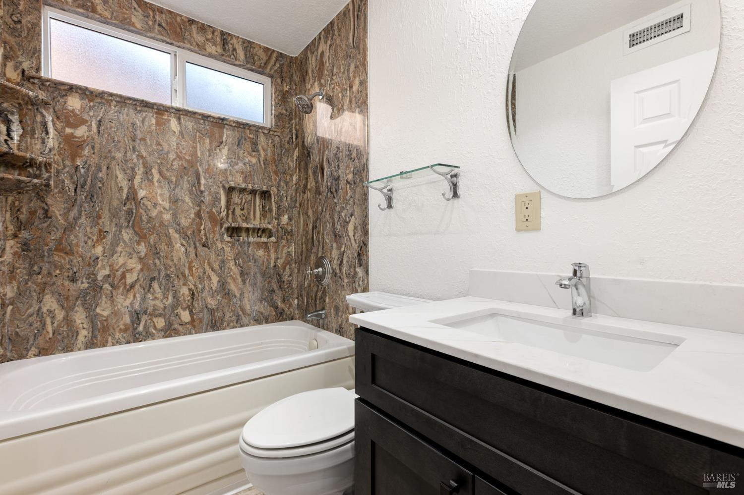 570 Berkeley Way Fairfield, CA 94533 - Photo 19 of 34 a bathroom with a sink a toilet and a mirror