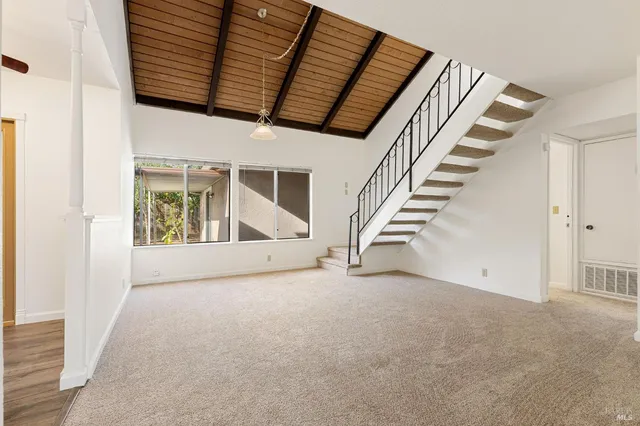 wooden floor with white walls and stairs