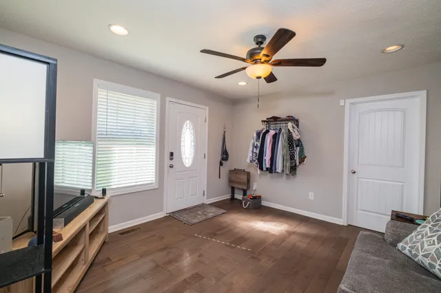 a view of a livingroom with a flesh screen tv and window