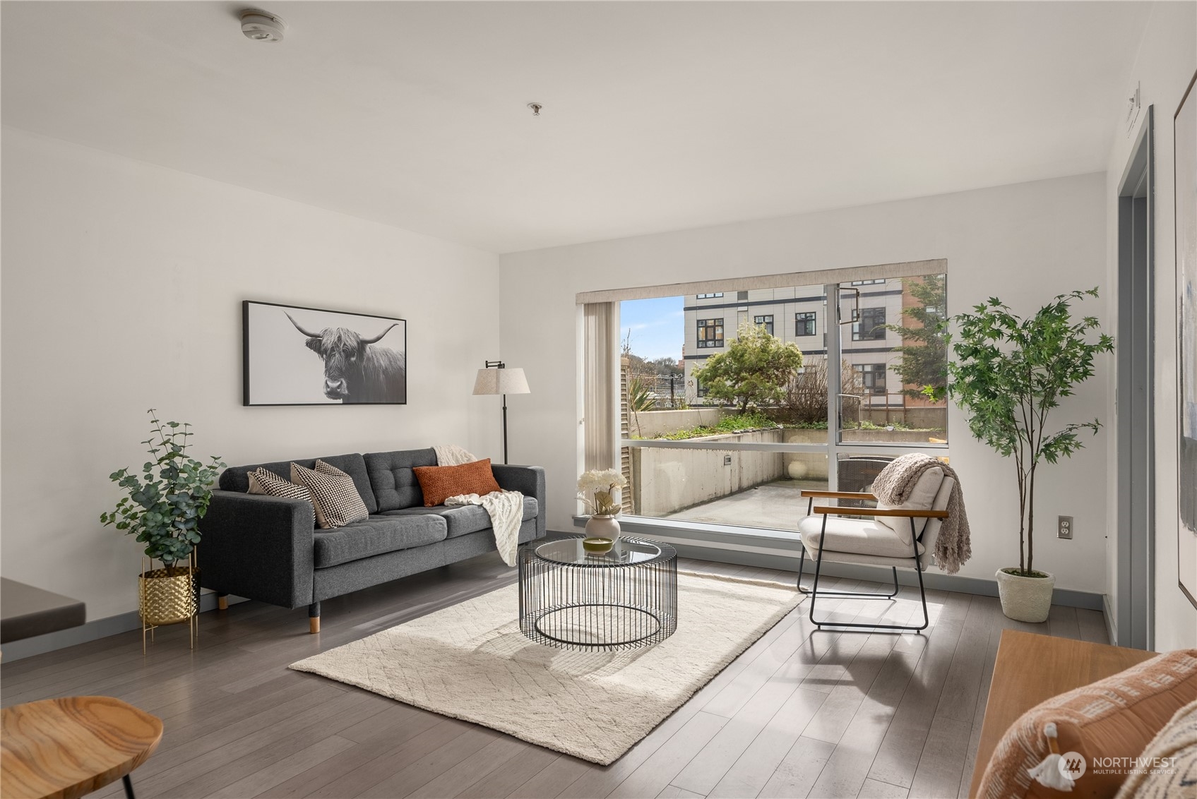 321 10th Avenue South, Unit 508 Seattle, WA 98104 - Photo 11 of 26 a living room with furniture and a large window
