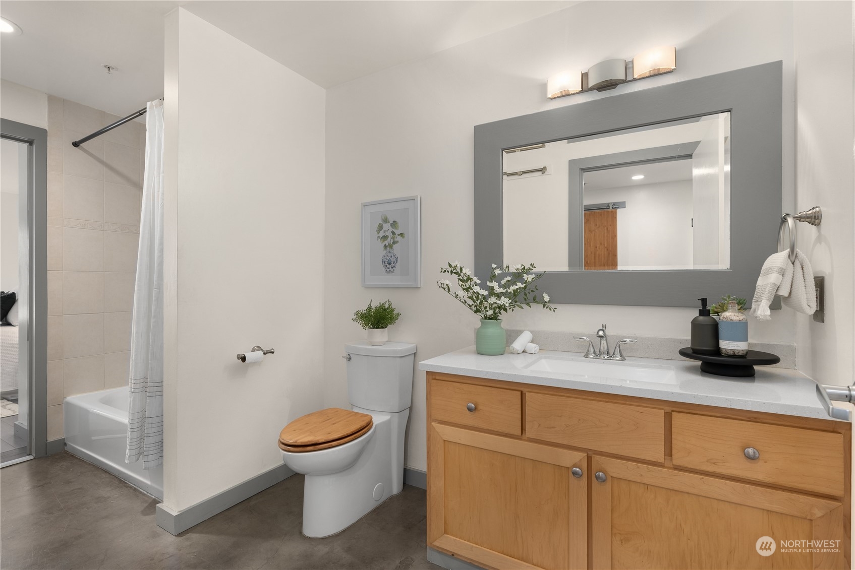 321 10th Avenue South, Unit 508 Seattle, WA 98104 - Photo 18 of 26 a bathroom with a toilet sink and mirror