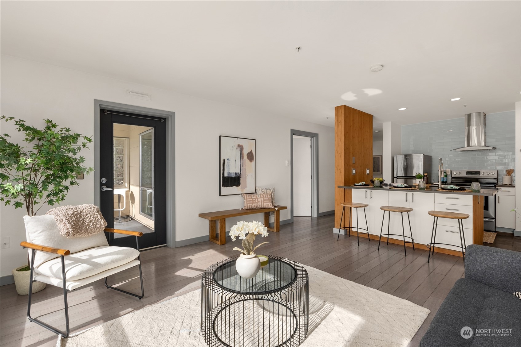 321 10th Avenue South, Unit 508 Seattle, WA 98104 - Photo 4 of 26 a living room with furniture kitchen view and a wooden floor