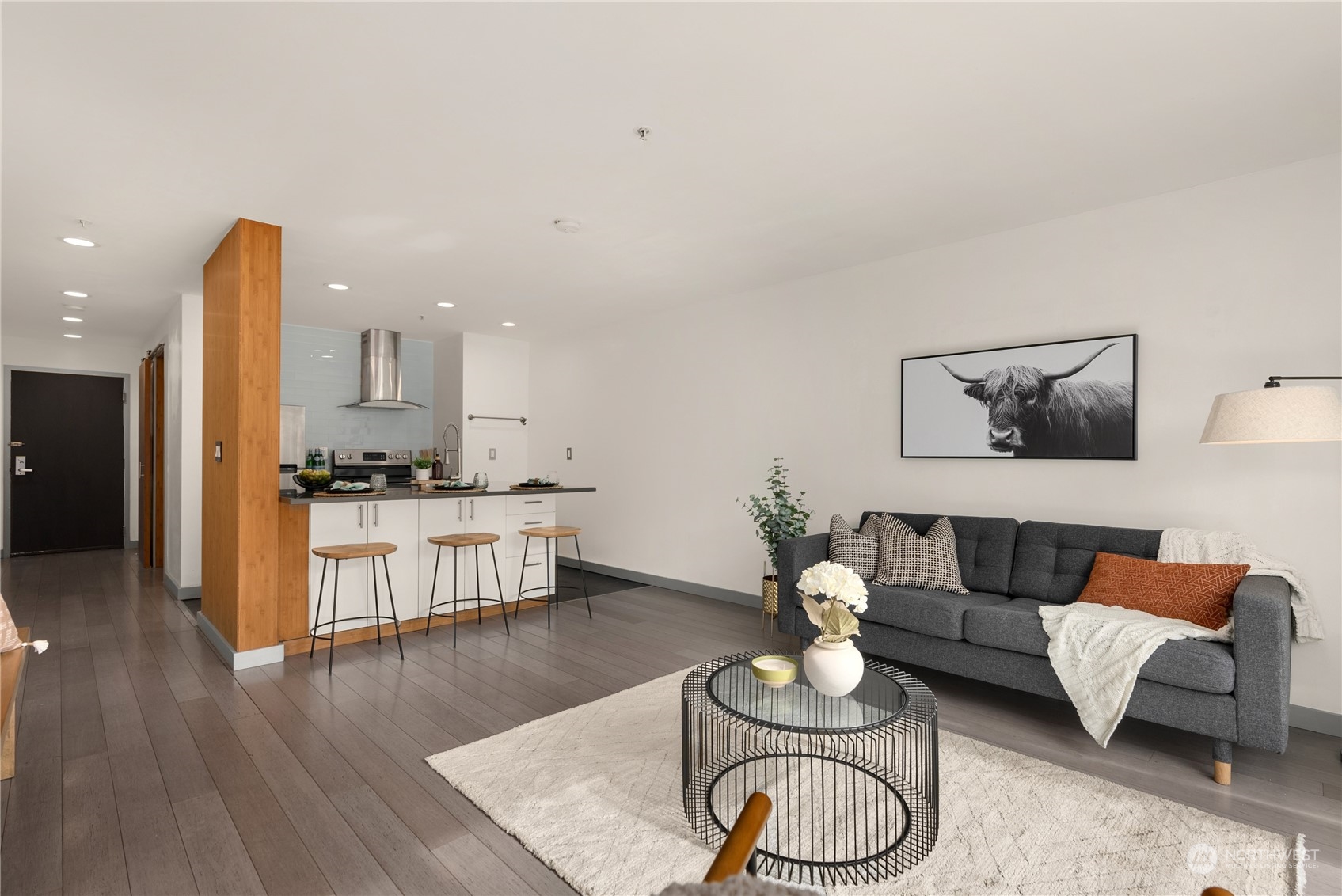 321 10th Avenue South, Unit 508 Seattle, WA 98104 - Photo 5 of 26 a living room with furniture kitchen view and a wooden floor