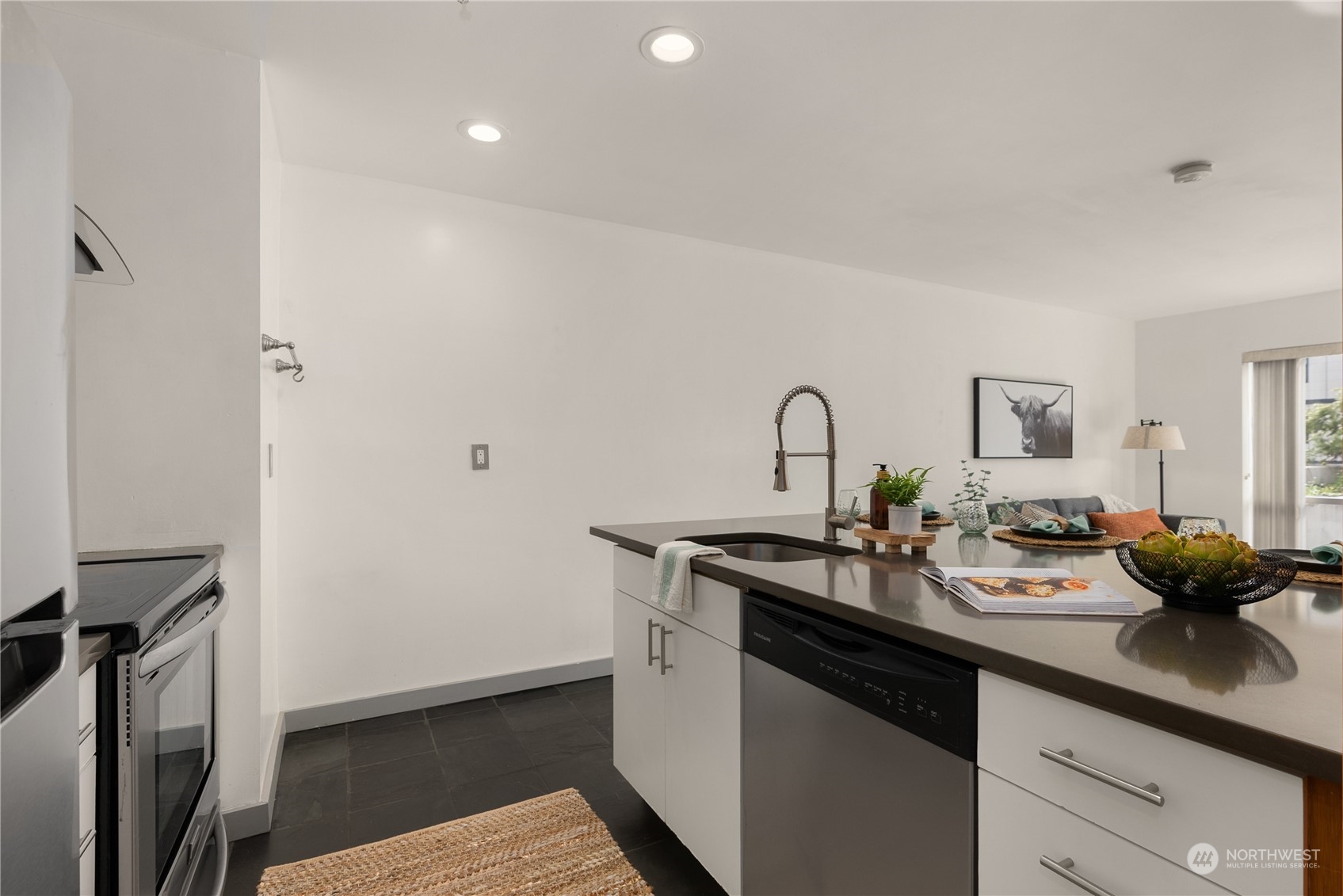 321 10th Avenue South, Unit 508 Seattle, WA 98104 - Photo 7 of 26 a kitchen with a sink and cabinets