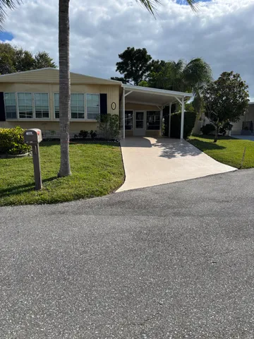 a view of a house with backyard porch and sitting area