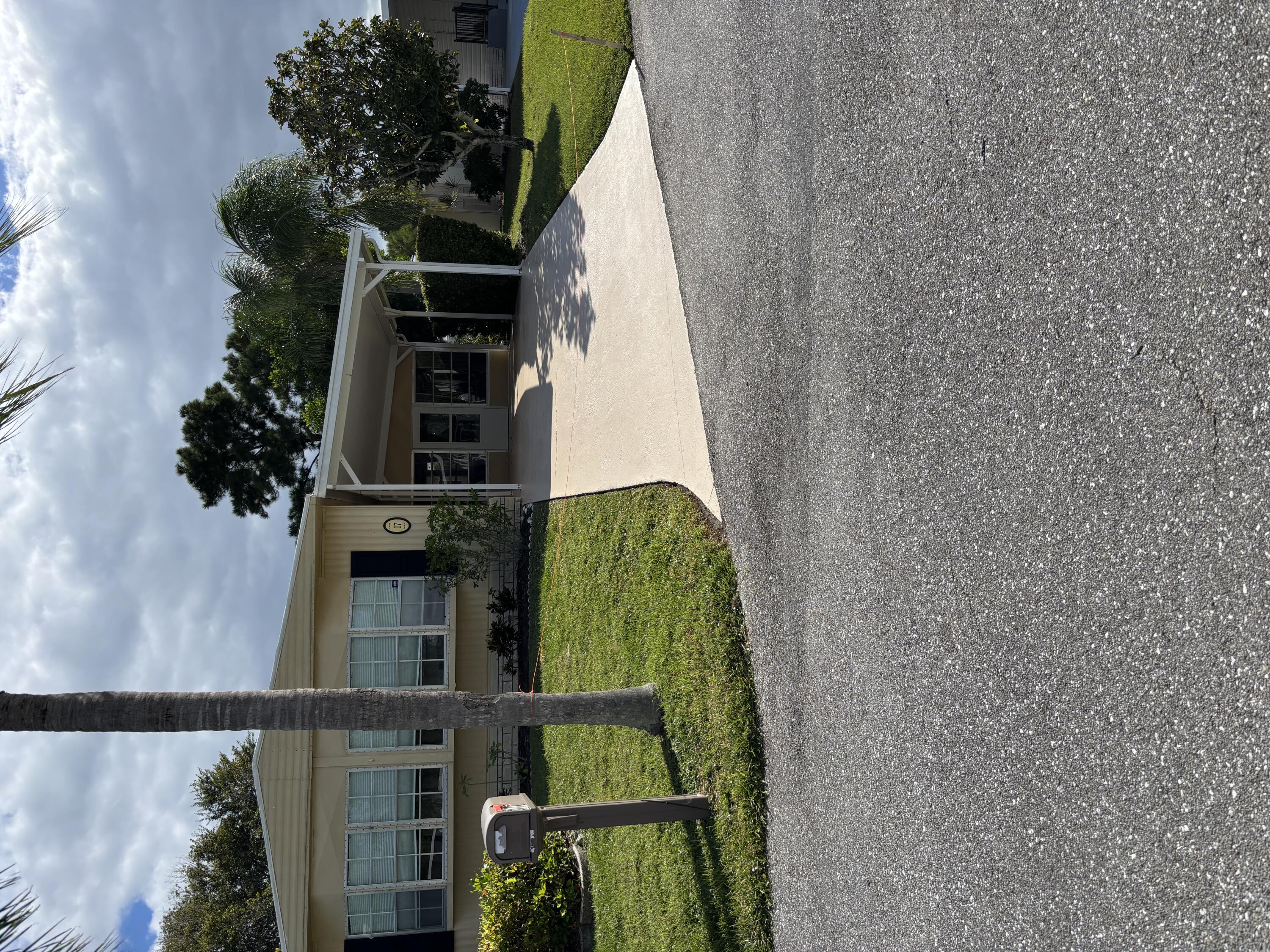 a view of a house with backyard porch and sitting area