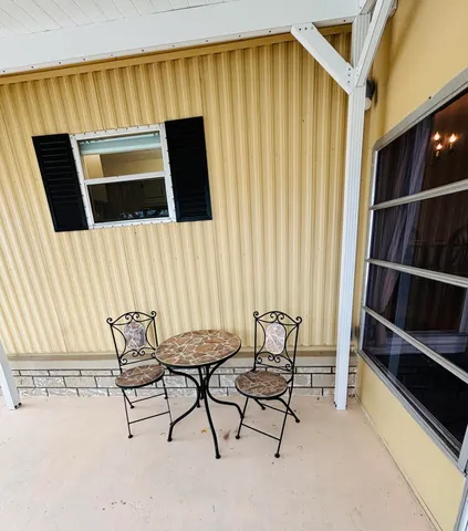 a view of a house with backyard and sitting area