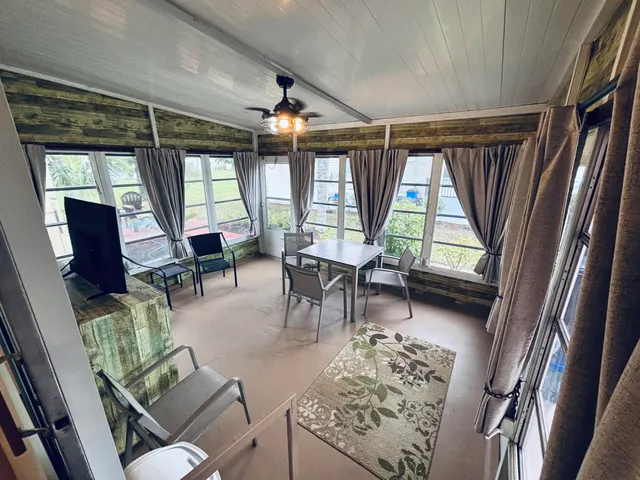 a room with pool tables and windows