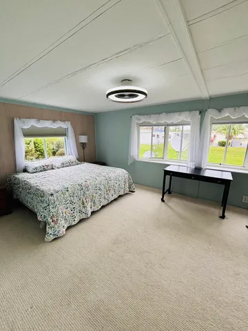 a bedroom with a bed and window