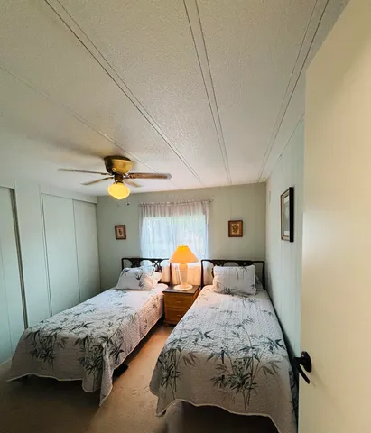 a bedroom with two beds and a chandelier