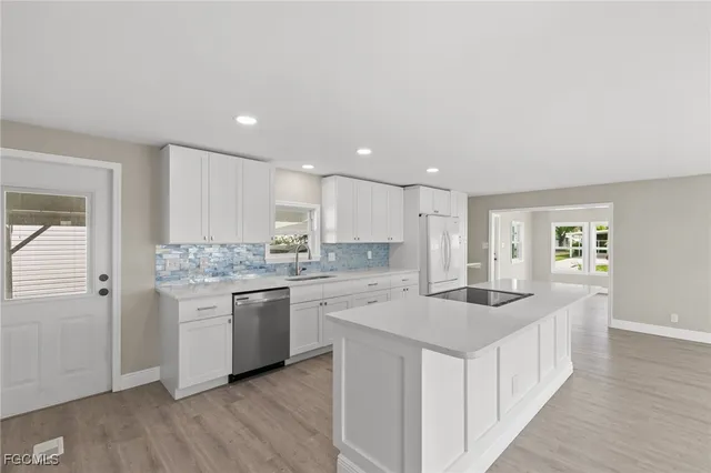 a kitchen with granite countertop a sink and cabinets