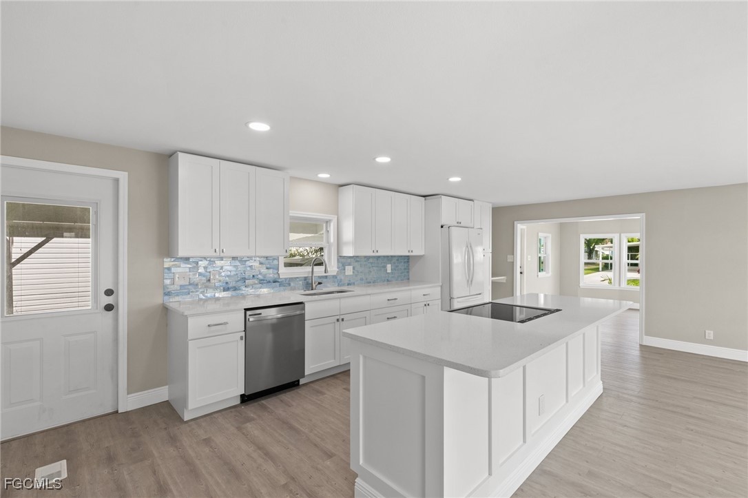 57 San Remo Circle Naples, FL 34112 - Photo 11 of 28 a kitchen with a sink stove and cabinets