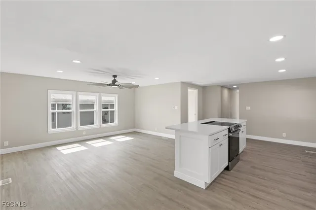 a view of kitchen with cabinet and refrigerator