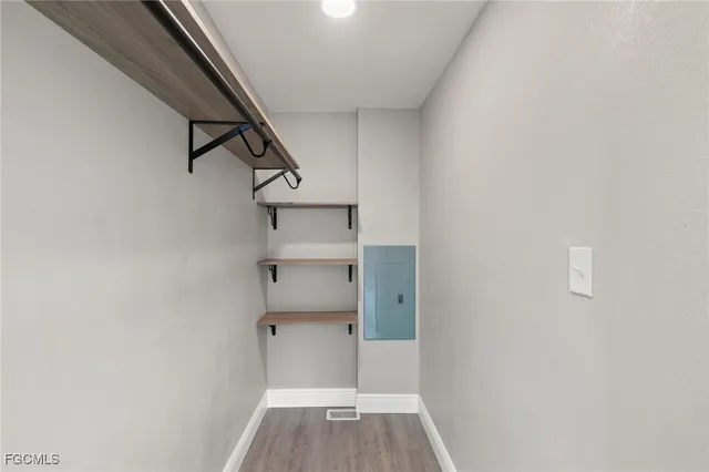 a bathroom with a toilet a sink a mirror and shower