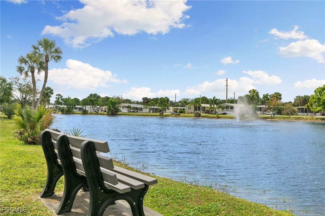 57 San Remo Circle Naples, FL 34112 - Photo 25 of 28 a view of outdoor space with seating area and trees in the background
