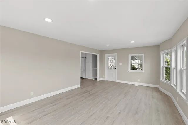 a kitchen with white cabinets and sink