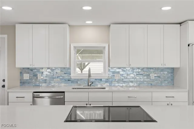 a kitchen with a sink stove and cabinets