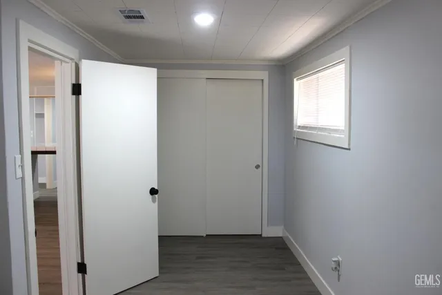 a view of hallway with wooden floor