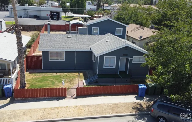 an aerial view of a house with a yard