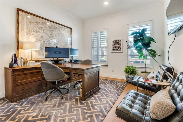 a view of a livingroom with workspace and a window