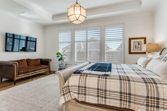 a bedroom with a bed and a chandelier