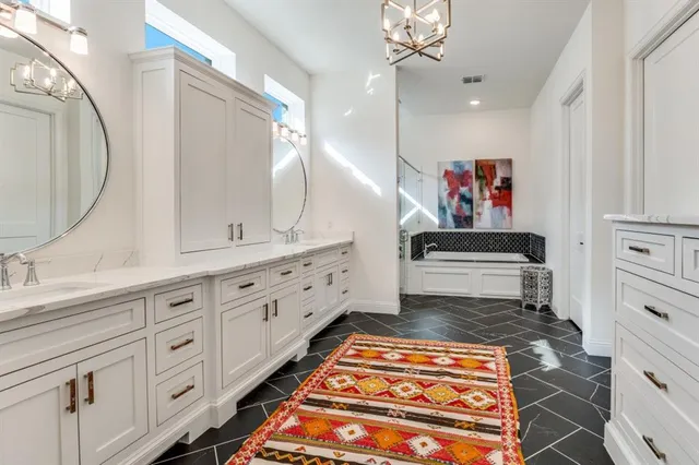 a spacious bathroom with a double vanity sink and a mirror