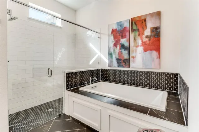 a bathroom with a bathtub and shower