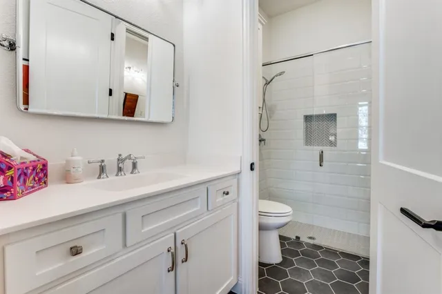 a bathroom with a sink a toilet and a mirror