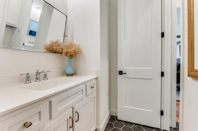 a bathroom with a sink a vanity and a mirror