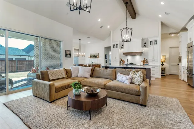 a living room with furniture and a chandelier