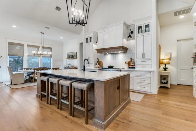 a kitchen with stainless steel appliances granite countertop a stove and a refrigerator