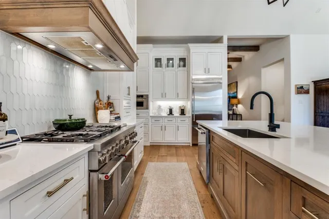 a kitchen with stainless steel appliances granite countertop a stove and a sink