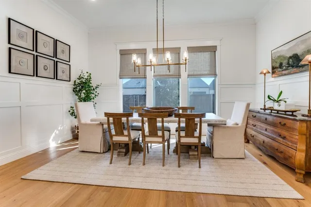 a dining room with furniture a chandelier and wooden floor