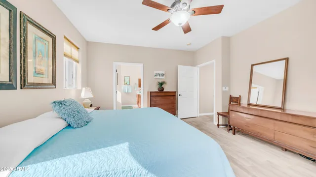 a bedroom with a bed and a large mirror